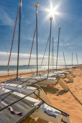 Catamaran empty. Catamaran stored on beach in La Baule France on blue sky.