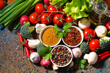 assortment of spices and fresh organic vegetables 