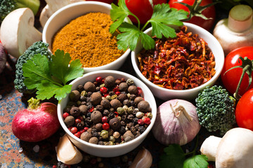 assortment of spices and fresh organic vegetables