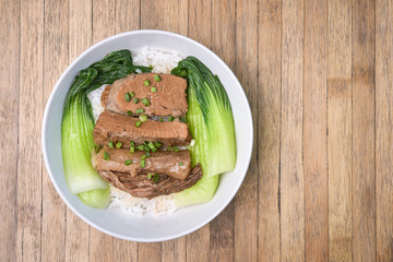 Roasted Pork with Bok Choy, Pak Choi Cabbage and rice on wood ba