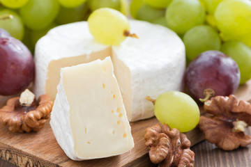 fresh camembert, walnuts and fresh grapes, selective focus