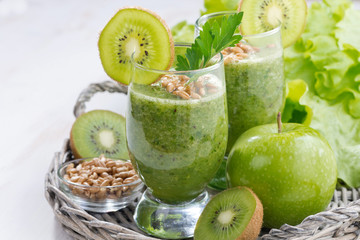 healthy green smoothie with sprouts on a white wooden table