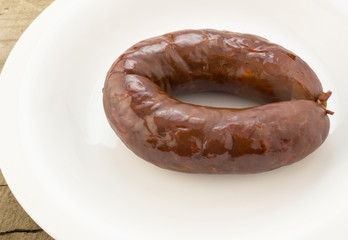 Chorizo sausage whole on white plate