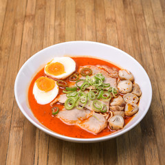 Spicy Tom Yum, Creamy Pork Ramen with egg and mushroom on wood b