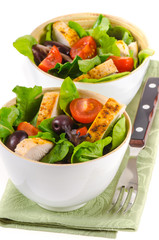 Fried chicken salad with cherry tomatoes and black olives