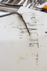 Abrasions front of a white car.