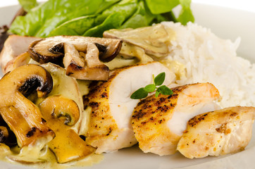 Fried spiced chicken breast cut and served with creamy mushroom