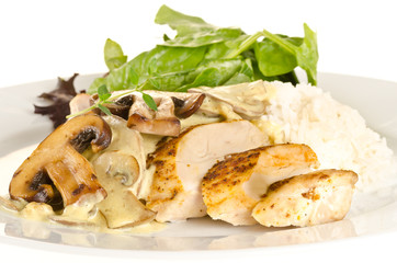 Fried spiced chicken breast cutted and served with creamy mushro