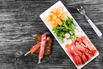 Arugula, prosciutto, mozzarella and melon  salad , top view