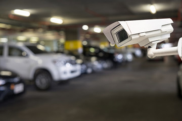 CCTV security camera on blur car parking