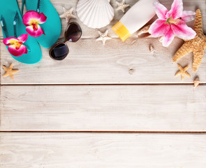 Beach accessories on wooden background