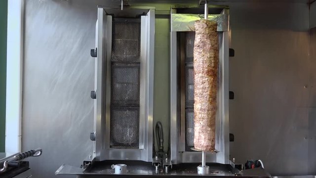 Doner Kebab In Turkish Restaurant In Paris, France. is a Turkish dish made of meat cooked on a vertical rotisserie, normally lamb but sometimes beef, or chicken.