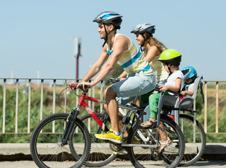 Fototapeta na wymiar Family of four traveling by bicycles