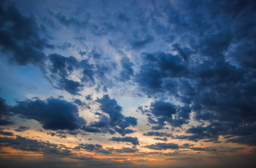 Big blue clouds on the sunset background.