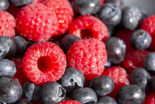 Dessert, fresh berries close-up. The texture of berries, raspberries and blue-berries, macro shot.