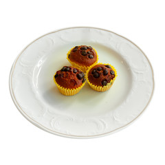 Chocolate & blueberry muffins in paper cases in white plate