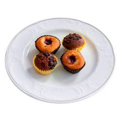 Chocolate & blueberry muffins in paper cases in white plate