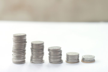 Coin stacks on a clear background, Selective focus.