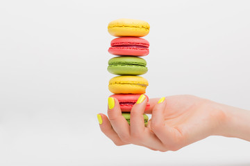 Person holding stack of macaroons
