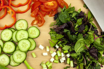 Above shot of freshly chopped onions, tomatos and leaf salad
