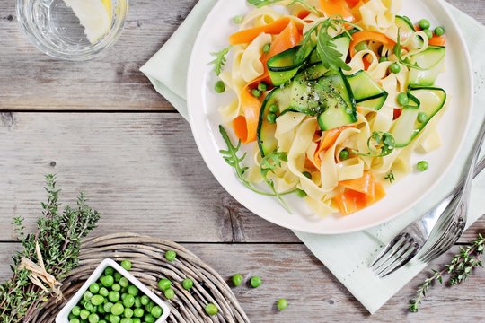 Spring pasta with zucchini ,carrots,green pea and arugula. Healthy eating.Selective focus