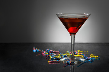 Manhattan cocktail with confetti on black background