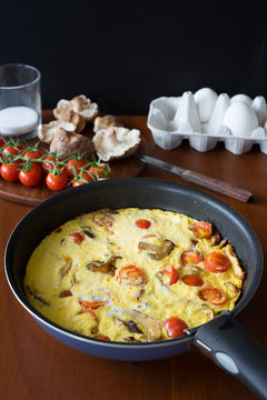 Frittata with cherry tomatoes and shiitake mushrooms. Selective focus.