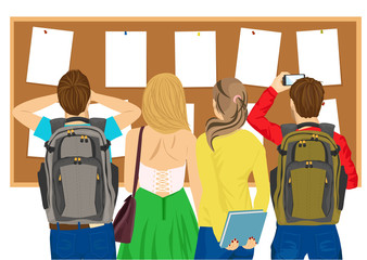 back view of college students looking at bulletin board