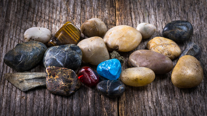Assorted pebbles on weathered barn wood background