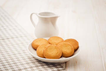 Biscuits on a white, wooden table with cloth