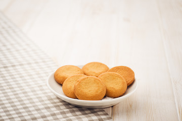 Biscuits on a white, wooden table with cloth