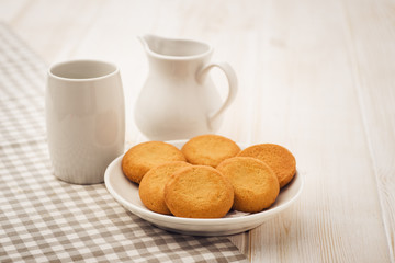 Biscuits on a white, wooden table with cloth