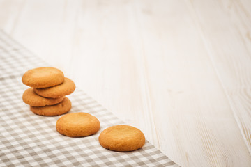 Biscuits on a white, wooden table with cloth