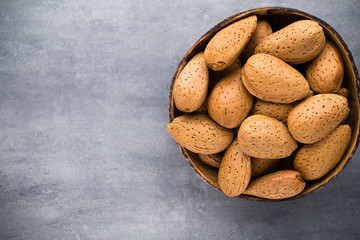 Group of almond nuts with leaves.Wooden background.