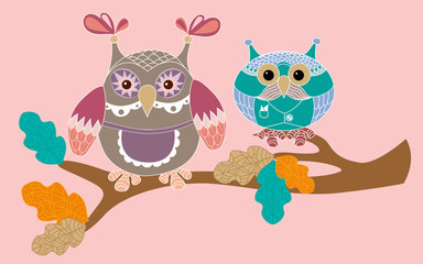 Couple of owls sitting on a branch