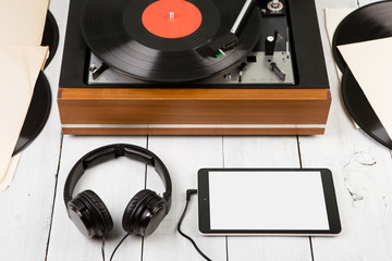 Vintage turntable, smartphone and headphones