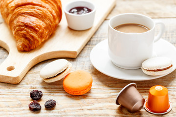 Breakfast with coffee and croissants on wooden table