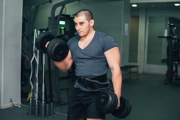 Fototapeta na wymiar man goes in for sports, fitness in the gym