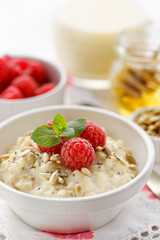 Porridge  with addition of fresh raspberries, roasted sunflower and chia seeds