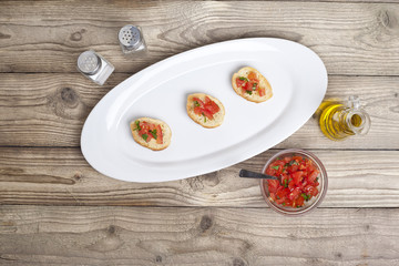 bruschetta slices in white plate