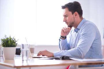 Concentrated man working on the laptop 