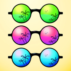 Trendy, round and vintage sunglasses with colorful lens reflect summer palms