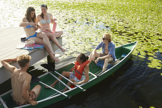 Friends rowing boat in lake, Seattle, Washington, USA