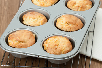 Homemade Cheddar Muffins In Baking Tray. Wooden Table.