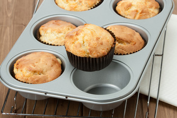 Homemade Cheddar Muffins In Baking Tray. Wooden Table.