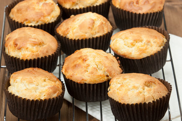 Homemade Cheddar Muffins In Paper Cases. Wooden Table.