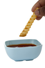 fried potato dipped in ketchup