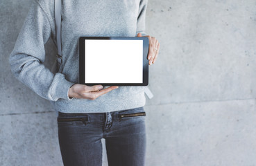 Close-up of hipster girl holding modern digital tablet with blank screen with copy space for your text message or content, mock-up of template touch pad or tablet pc, outdoors