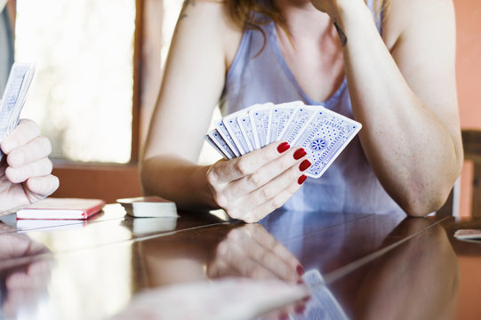 Cropped shot of young woman playing cards