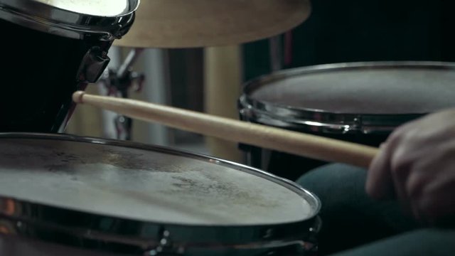 Musician playing drums at studio, close up